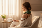 Trapezius Massager Pro in use on shoulder, golden hour bedroom lifestyle shot